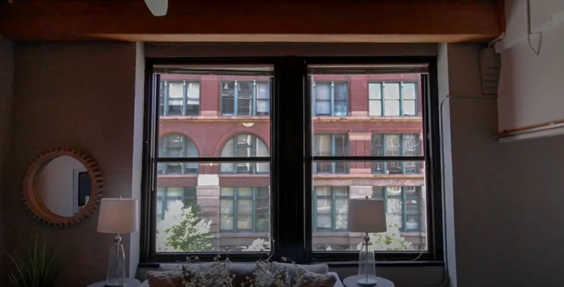 the view from the living room window of a red brick building