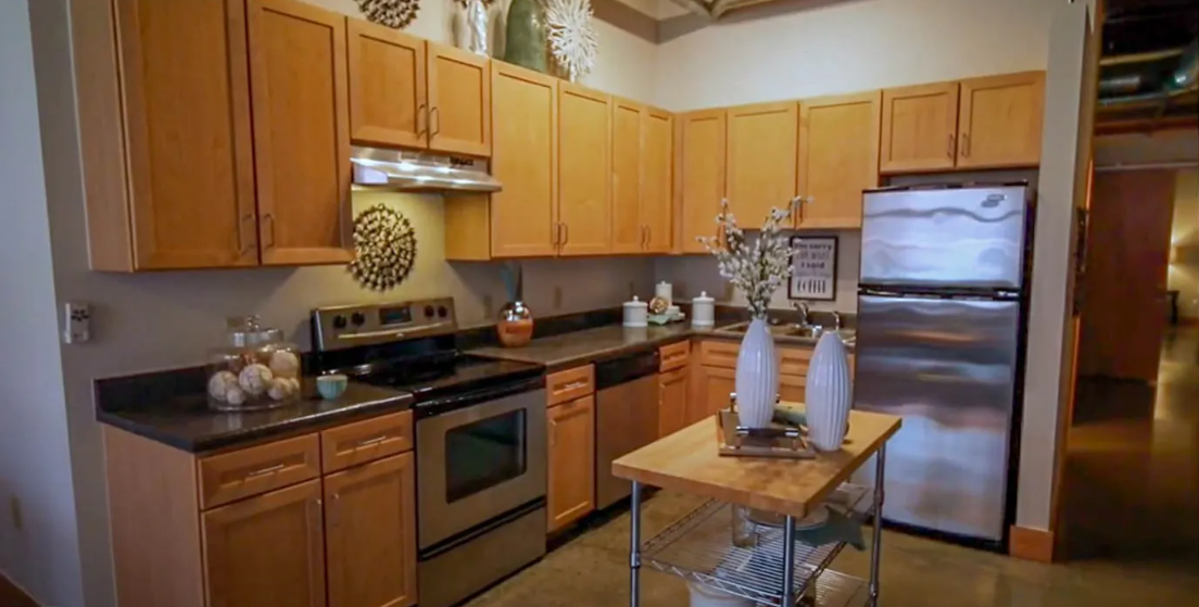 a kitchen with wooden cabinets and stainless steel appliances