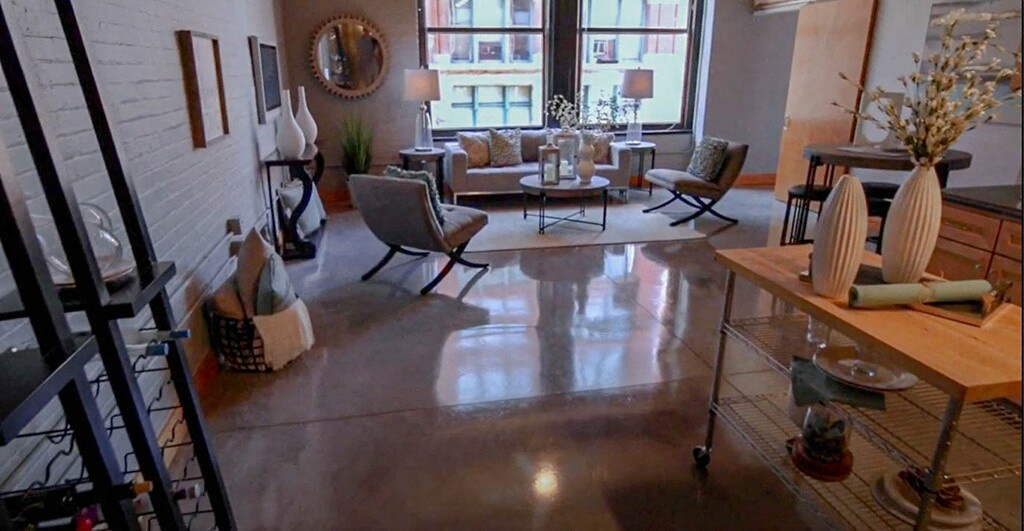 a living room filled with furniture and a large window