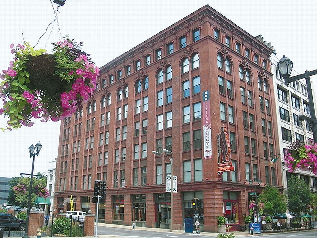 a large brick building on the corner of a city street