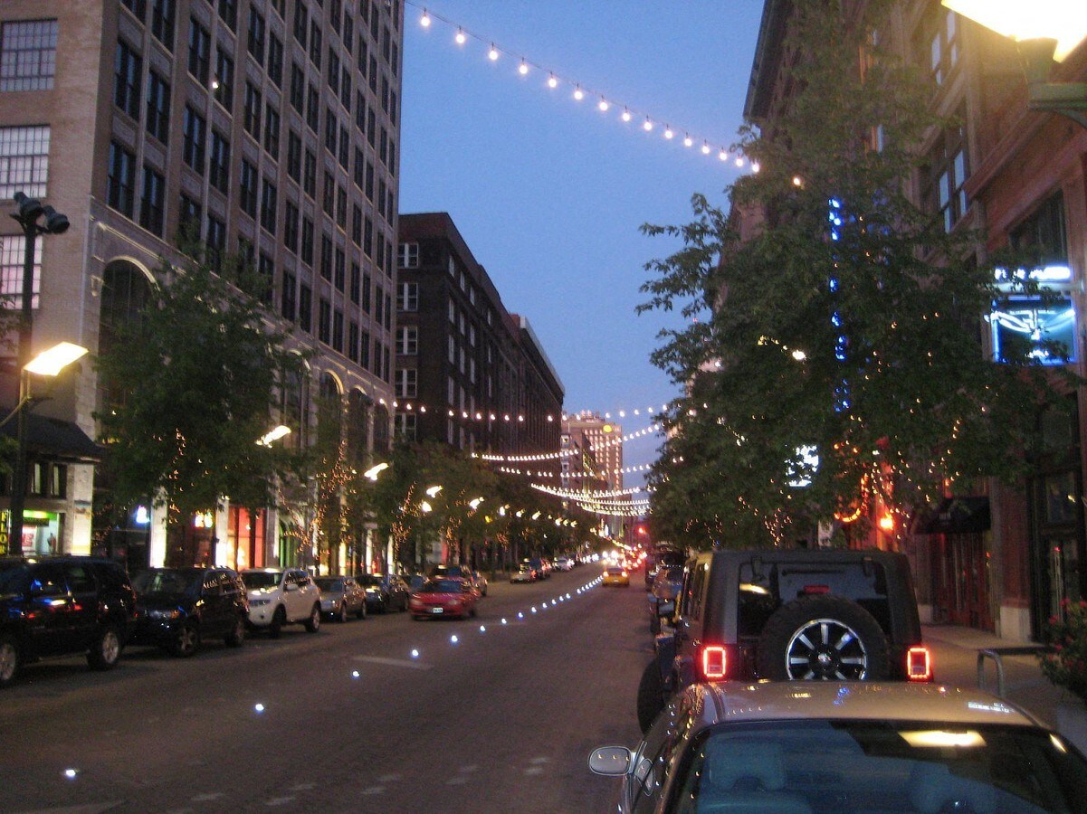 a city at night with christmas lights on the street