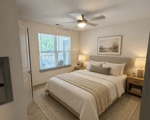 A bedroom with a large bed and a ceiling fan.