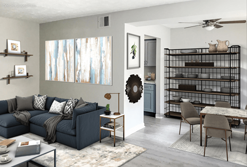 A living room with a blue couch and a wreath on the wall.