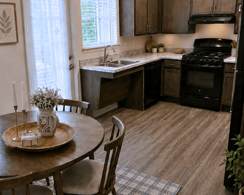 A kitchen with a table and chairs in front of a window.