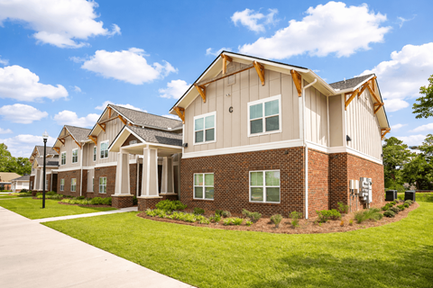 A modern house with a combination of brick and siding exterior.