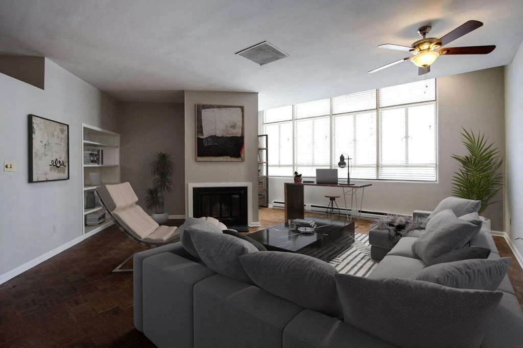 a living room with a couch and a ceiling fan