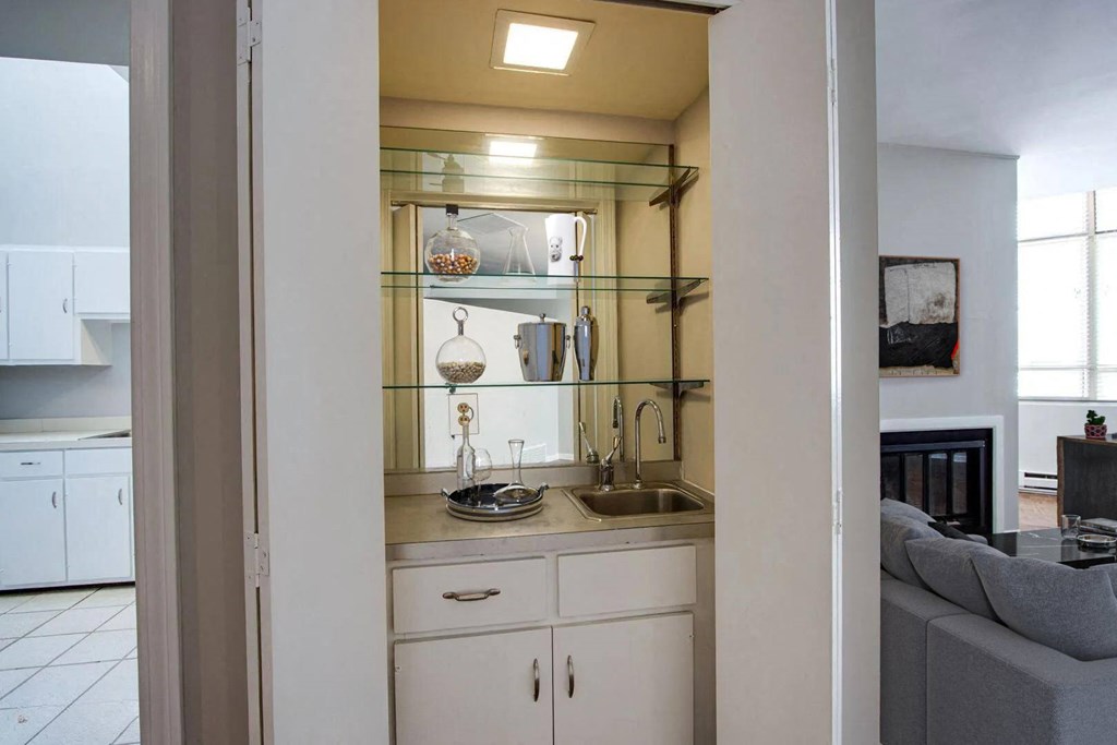 a small kitchen with a sink and a mirror