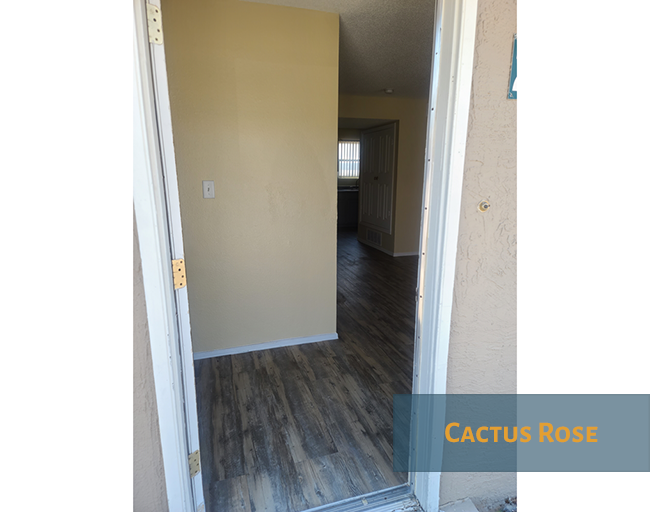 A hallway with a doorway leading to another room.