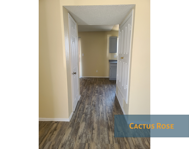 A hallway with a Cactus Rose sign on the floor.