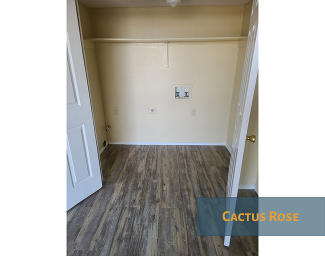 A room with a white door and a light switch on the wall.