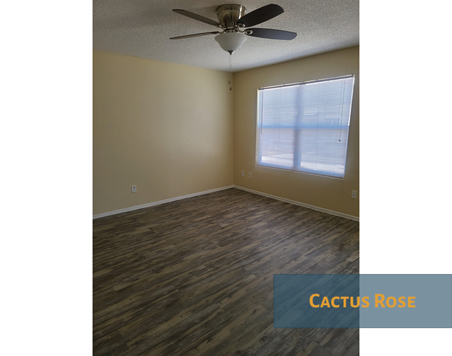 A room with a ceiling fan and a window.