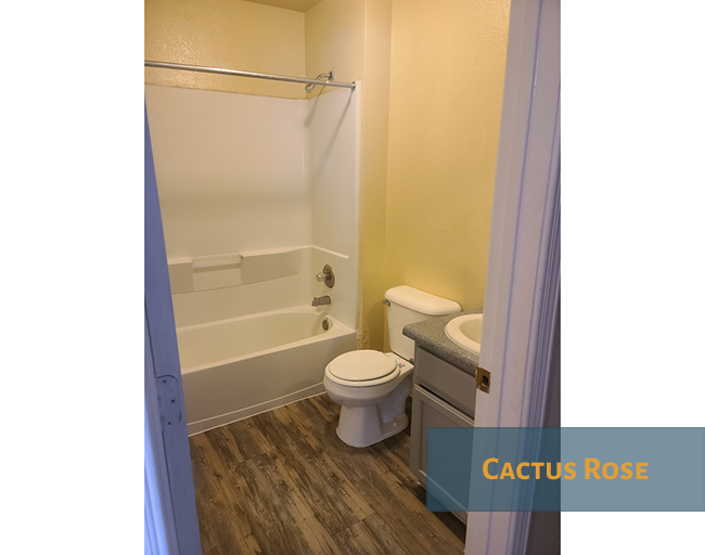 A bathroom with a toilet, sink, and bathtub.