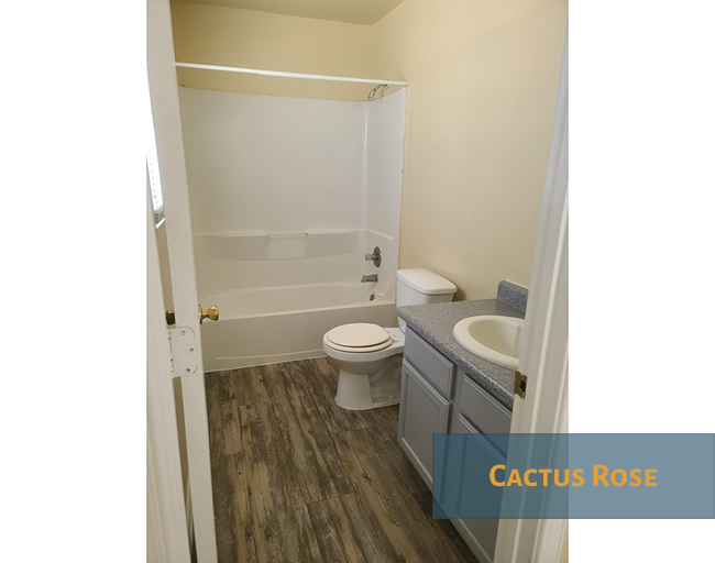 A bathroom with a toilet, sink and bathtub.