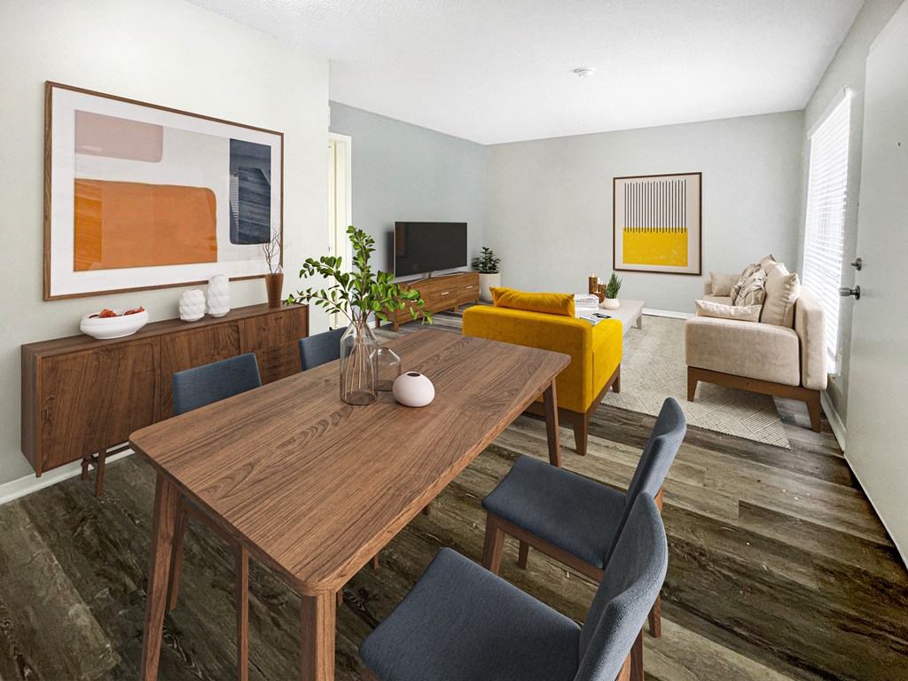 a living room and dining room with a wooden table at The Junction, Memphis, TN, 38111