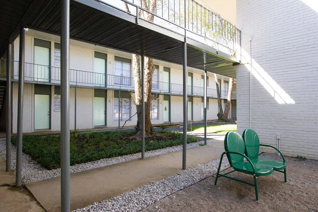 a patio with two chairs and a walkway in front of a building at The Junction, Memphis, TN, 38111