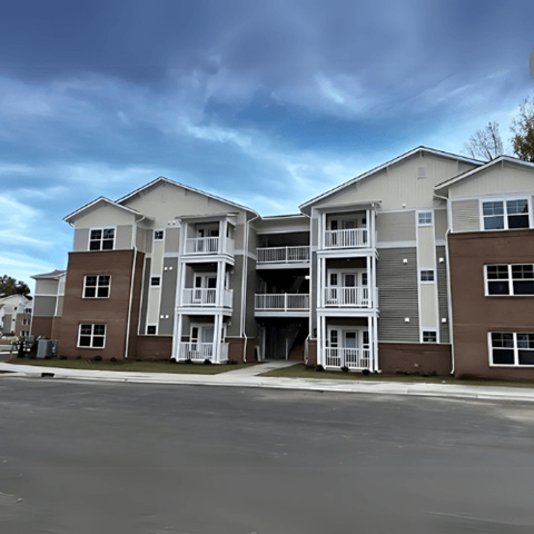 Apartment complex with multiple buildings and balconies.