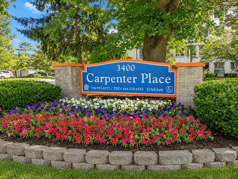 A sign for Carpenter Place with a phone number on it.