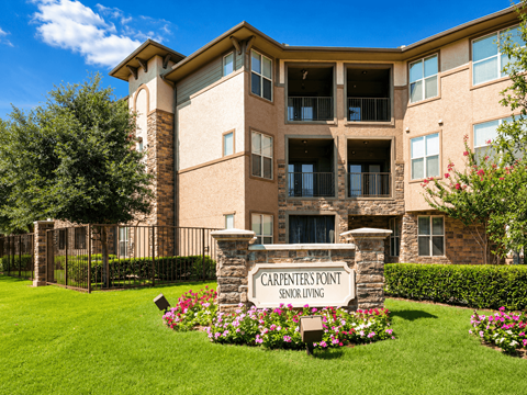A building with a sign that says Carpenters Point Senior Living.