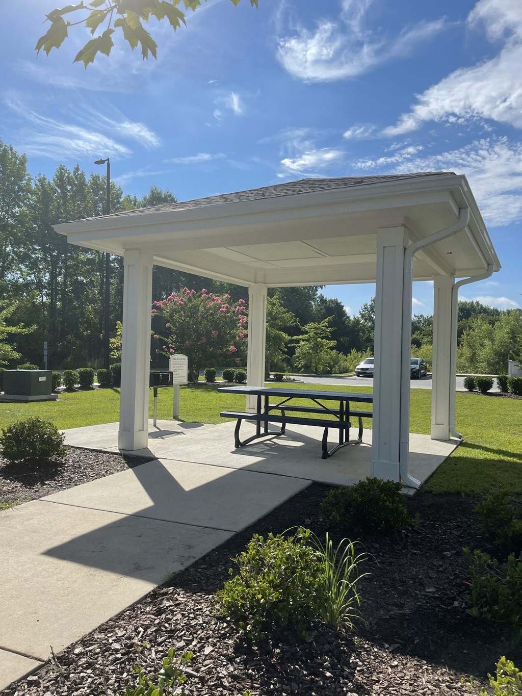 a pavilion with a picnic table in a park