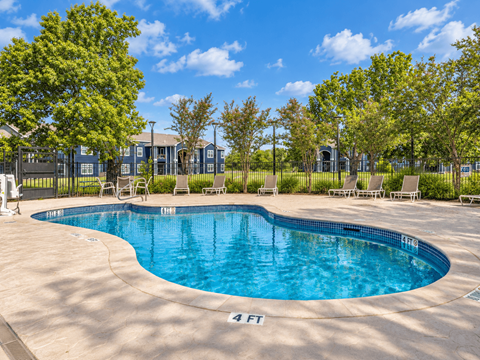 A swimming pool with a person standing on the side.