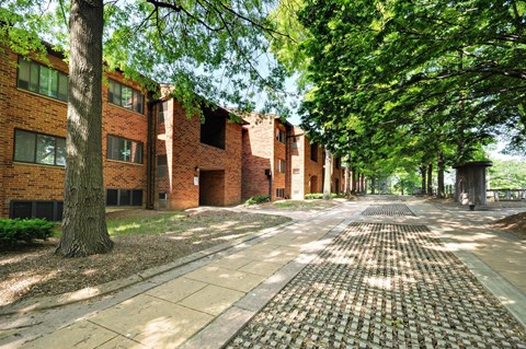 A brick building with a tree in front of it.