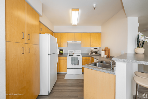 A kitchen with wooden cabinets and a white refrigerator.