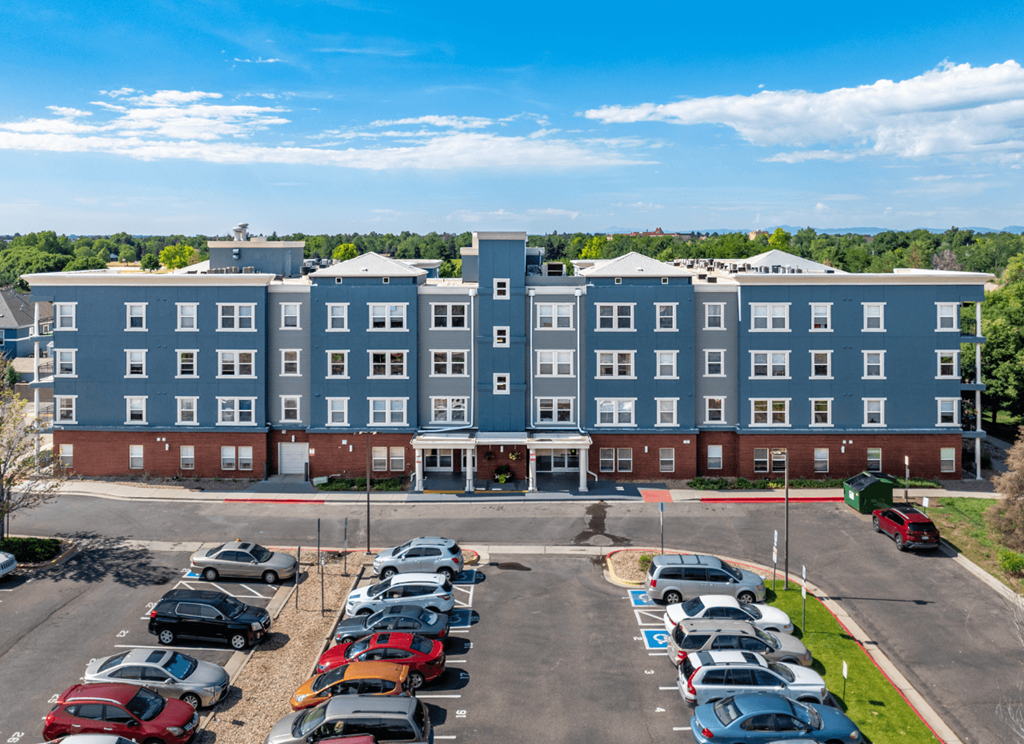 A large building with a parking lot in front of it.