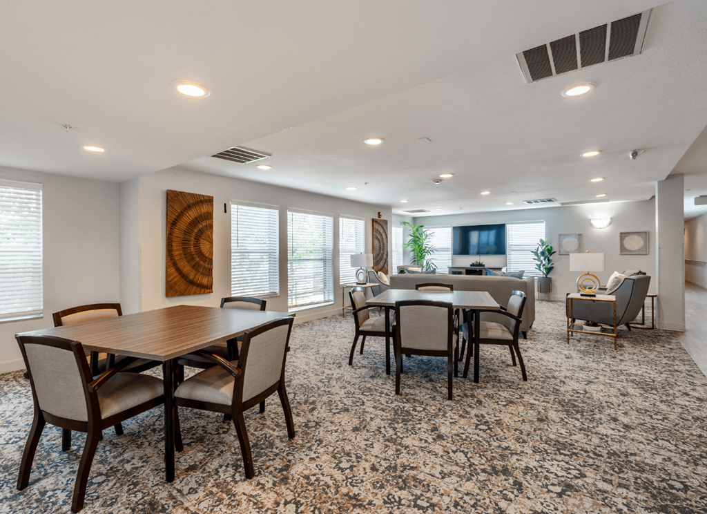 A dining room with a large table and chairs.