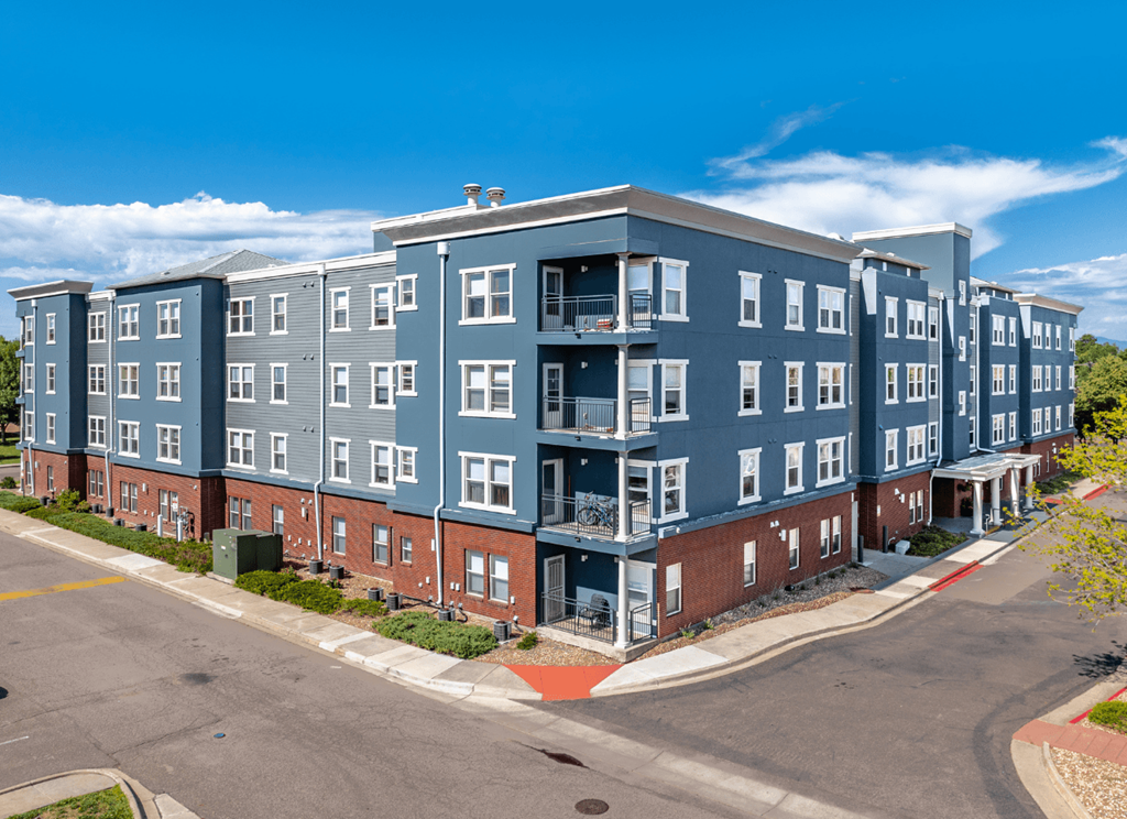 A large apartment complex with multiple buildings and balconies.
