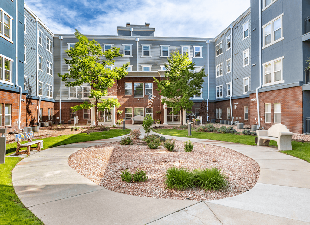 A courtyard with a circular garden in the middle of a residential area.