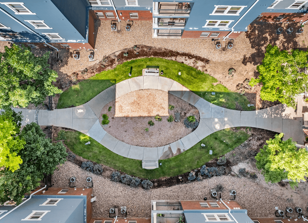 A courtyard surrounded by buildings with a circular design.
