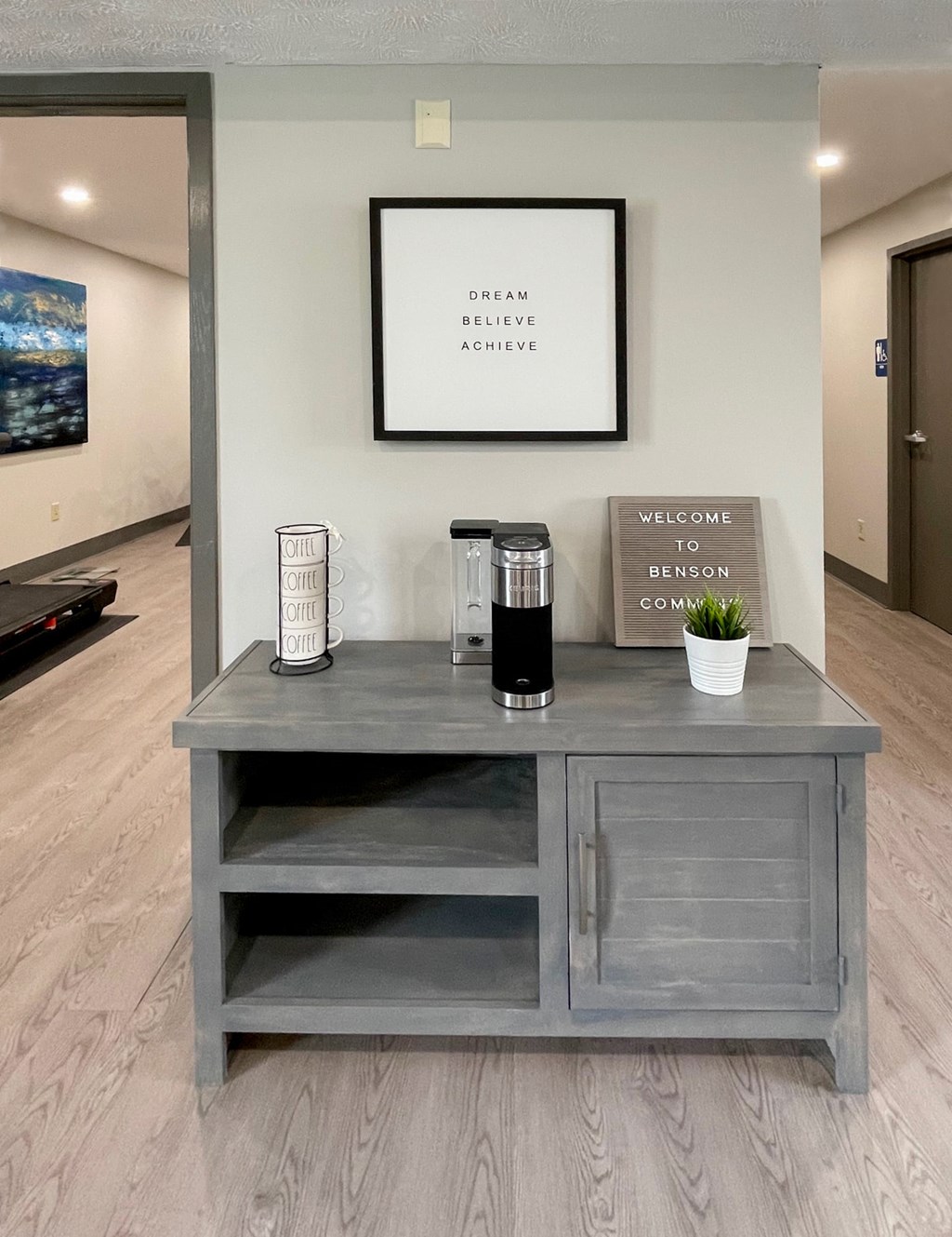 A grey cabinet with a sign that says "Welcome to Benson Commons" is in the foreground.