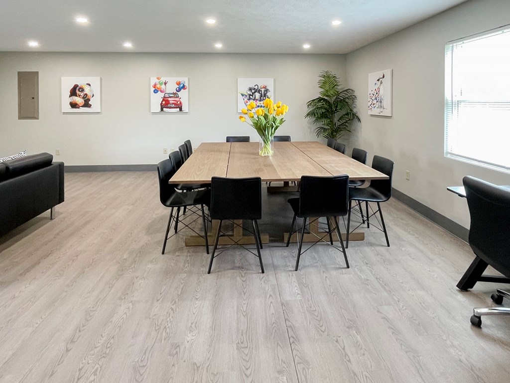 A conference room with a long table and chairs.