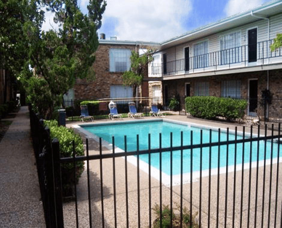 a swimming pool in front of an apartment building