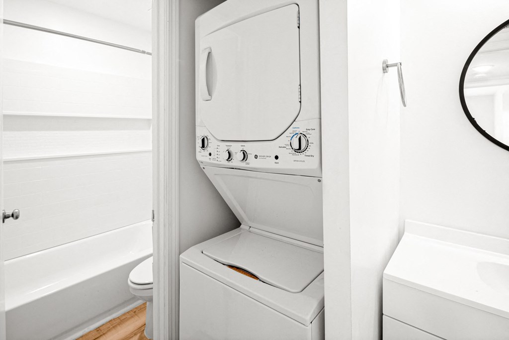 a small bathroom with a washer and dryer in it at The Courts Midtown, Memphis, TN, 38104