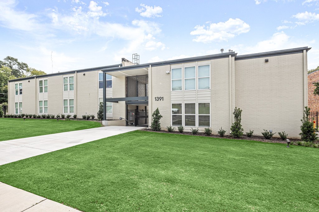 the front of an apartment building with a lawn and sidewalk at The Courts Midtown, Tennessee