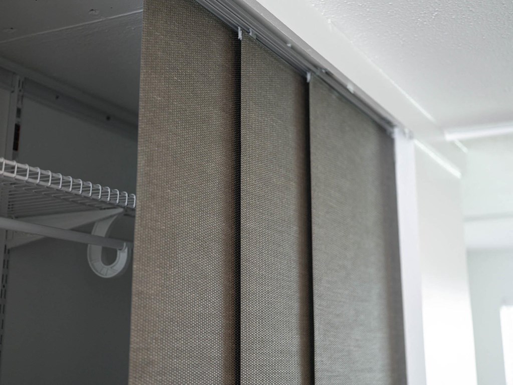 a shower curtain is hanging on the side of a closet at The Courts Midtown, Memphis, TN