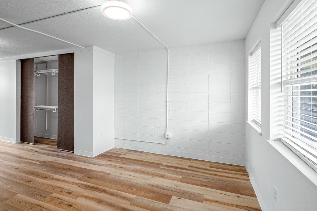 an empty room with wood floors and white walls and a glass closet at The Courts Midtown, Memphis, TN, 38104