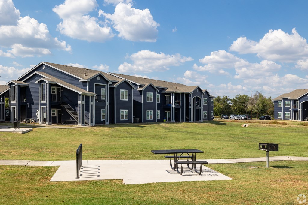 A row of houses with a picnic table in front.