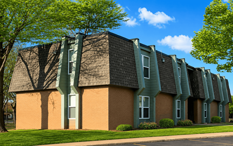 A building with a green roof and a brick facade.
