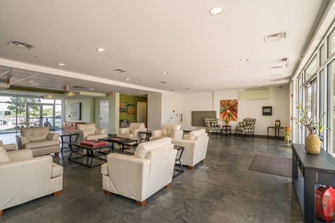 A spacious living room with white furniture and a fireplace.