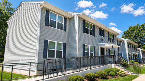 A grey house with black railings and windows.