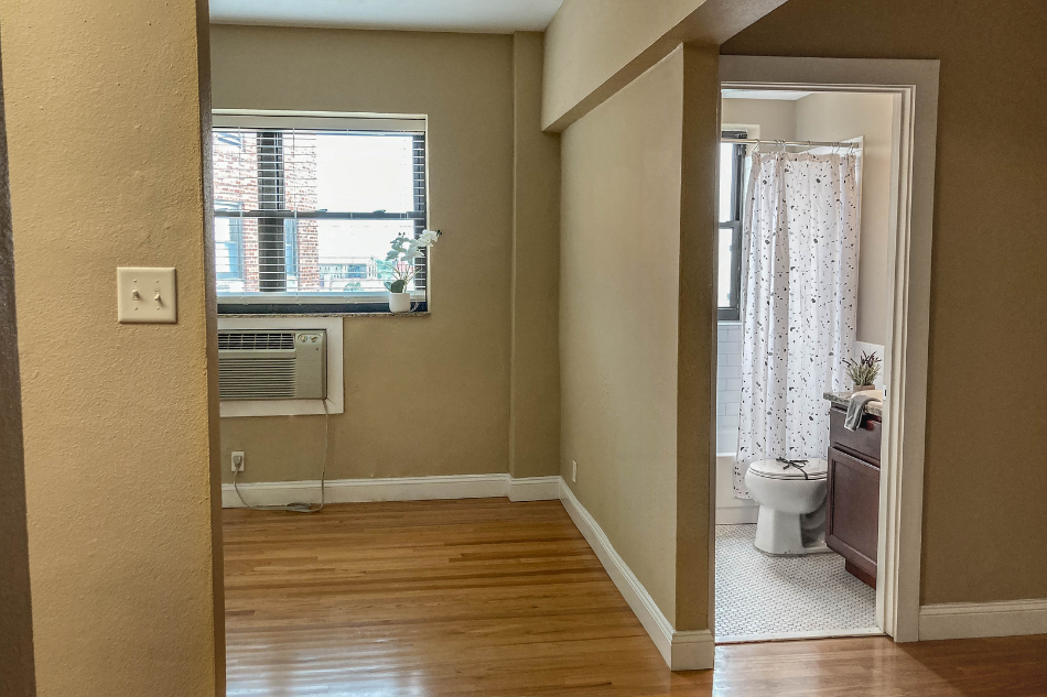 a room with a toilet and a window in it