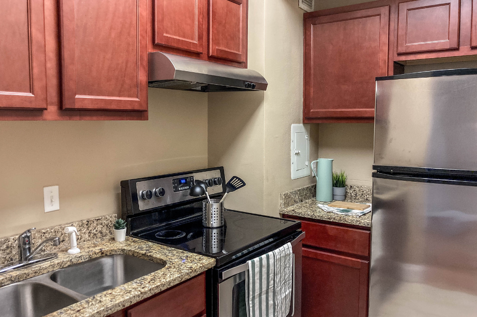 a kitchen with stainless steel appliances and granite counter tops