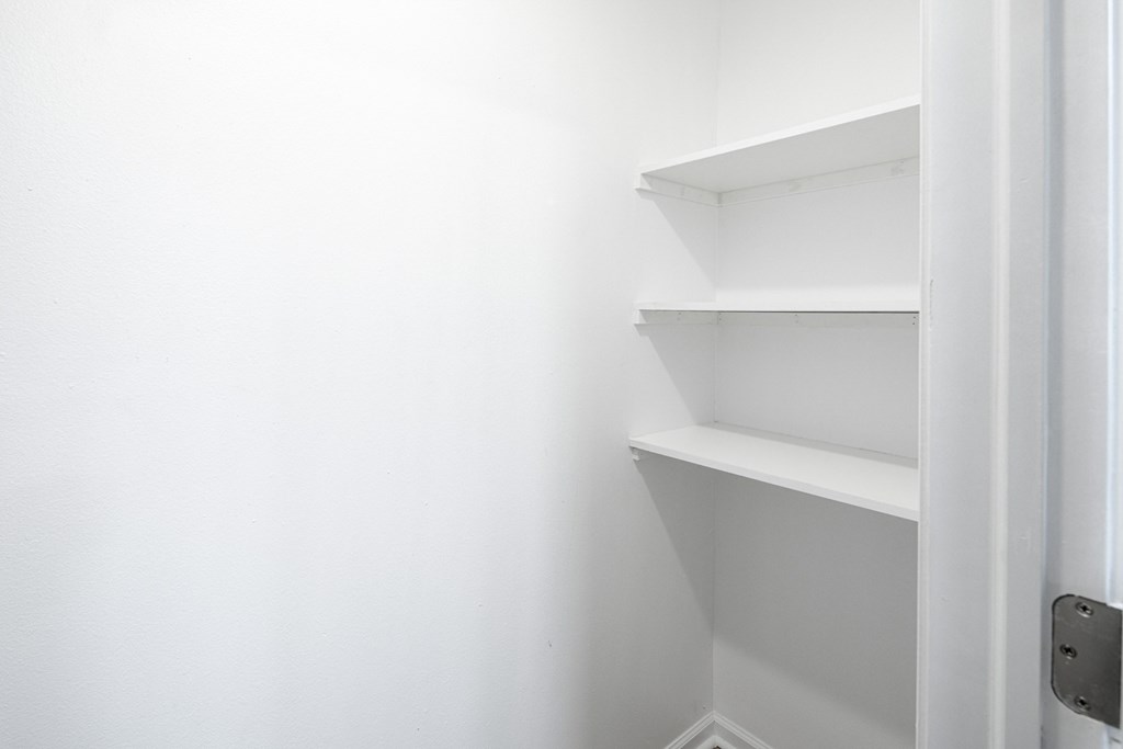 Empty white shelves in a room.