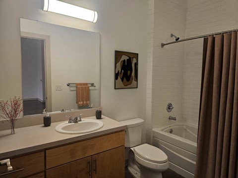 A bathroom with a white sink, toilet, and bathtub.at South Main Artspace Lofts, Memphis, TN