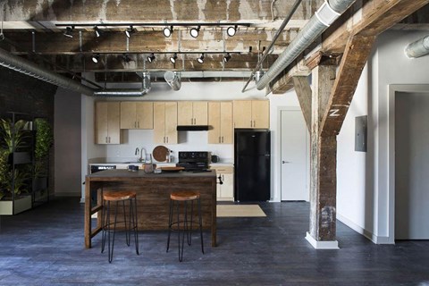 A kitchen with a bar stool in front of it.at South Main Artspace Lofts, Memphis, 38126