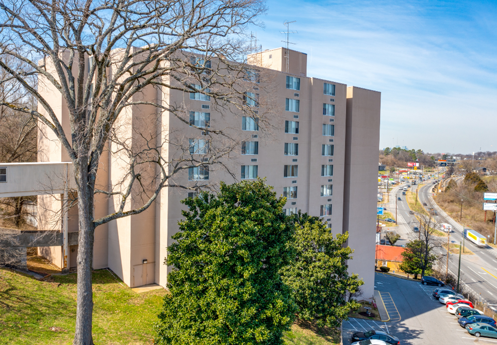 a large white building with a tree in front of it