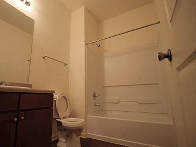 a bathroom with a toilet and a shower and a sink