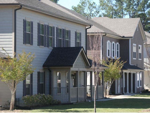 a row of houses with trees in front of them